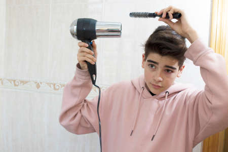 young combing in the mirrorの写真素材