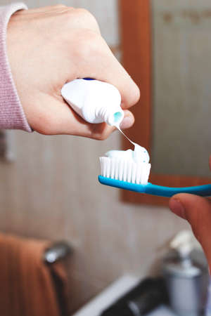 hands with toothpaste and toothbrushの写真素材