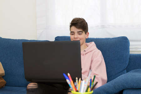 teenager with the laptop at home in the living room