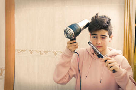 young combing in the mirrorの写真素材