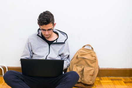 student with the computer and backpack of the college or university