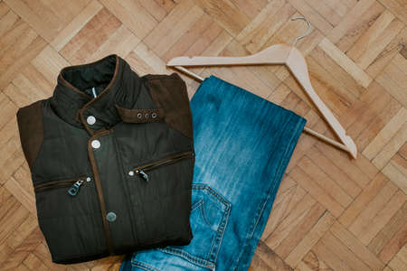 jeans and jacket with the perch on wooden bottomの写真素材