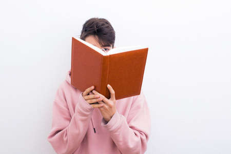 adolescent or preadolescent student with book on white background