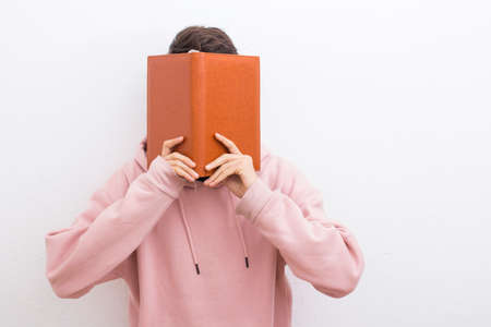 adolescent or preadolescent student with book on white background
