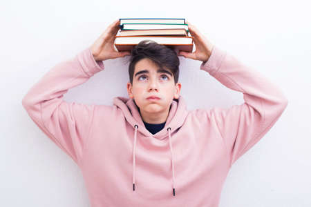 adolescent or preadolescent student with book on white backgroundの写真素材