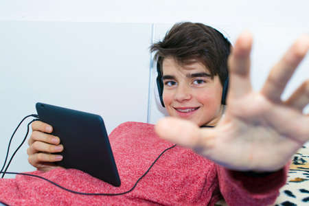 isolated child listening to music with headphonesの写真素材