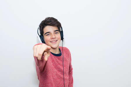 teen with headphones dancing on white backgroundの写真素材