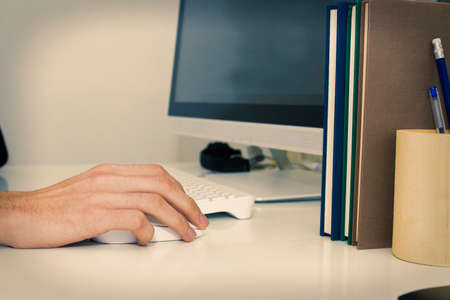 closeup your hands on the desktop with your computerの写真素材