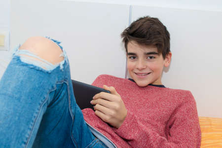 modern young teenager with a tablet at homeの写真素材