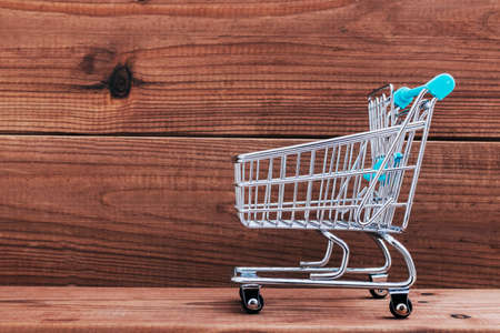 shopping cart on wooden bottomの写真素材