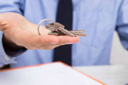 hands with keys, concept of buying or renting house or apartmentの写真素材