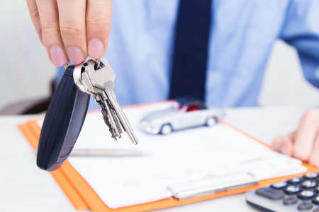 business man hand with keys and car control
