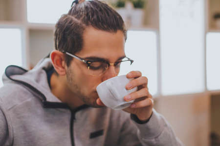 young to the fashion drinking coffeeの写真素材