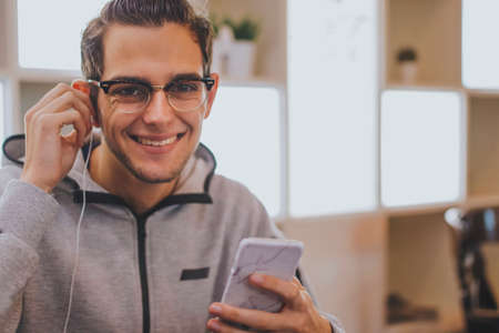 young fashion with mobile phone and earphonesの写真素材