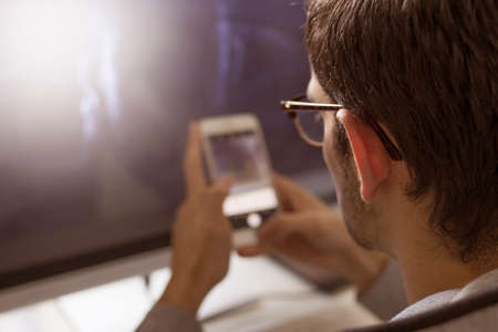 young with mobile phone and computerの写真素材