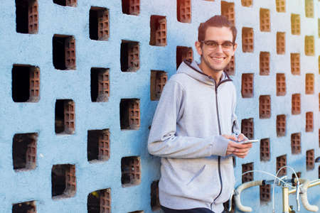 young with mobile on street city