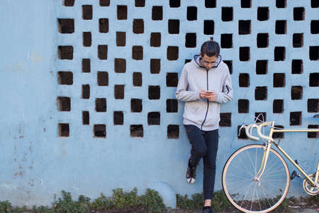 young with mobile on street city