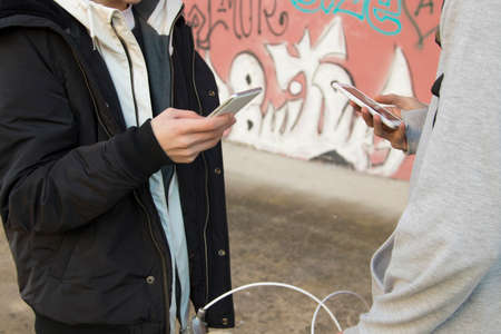 hands of people with mobile phone in the streetの写真素材