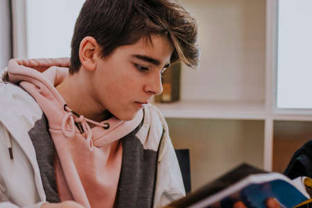 young teenager reading the book or magazineの写真素材