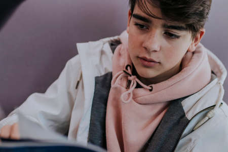 A teenage student reading a book or studyingの写真素材