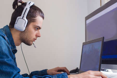 young with headphones and computer
