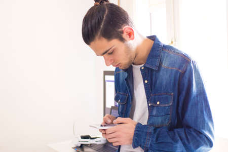 young with mobile phoneの写真素材