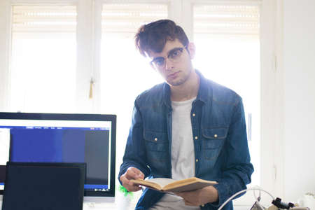 students with the book and computer in the room and deskの写真素材