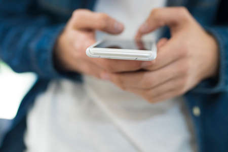 young hands with a mobile phone in the foreground