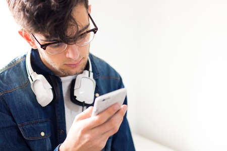 young man with earphones and mobile phone