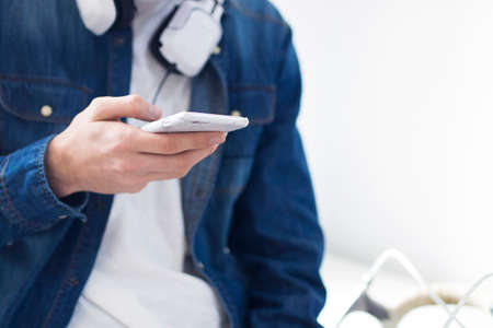 young man's hand with mobile phone