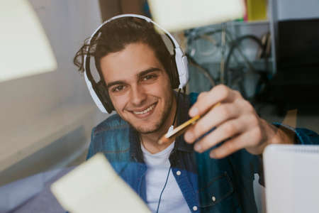 working with headphones at home or in the office at the deskの写真素材