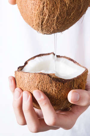 Natural coconut milk in the handsの写真素材