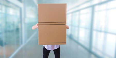 Man with stacked cardboard boxes of moving