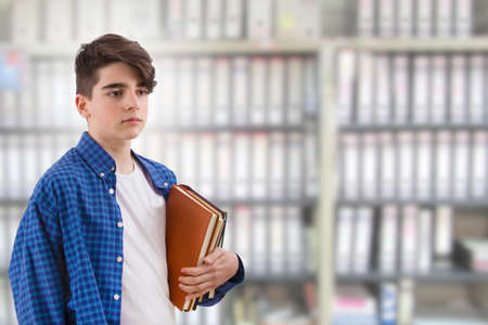 student with books in the libraryの写真素材