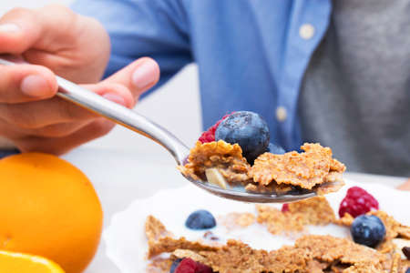 spoon with cereals and fruits, breakfast and healthy snack