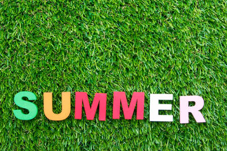 summer background with letters on green grassの写真素材