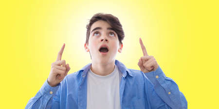 portrait of teenager with expression of astonishment looking up