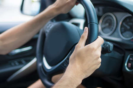 man hands driving the car