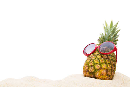 pineapple with sunglasses in the summer landscape on the beachの写真素材
