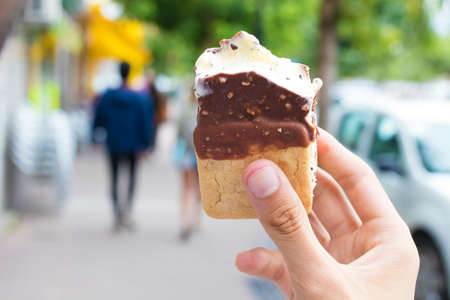 eating ice cream outdoors on the street in summerの写真素材