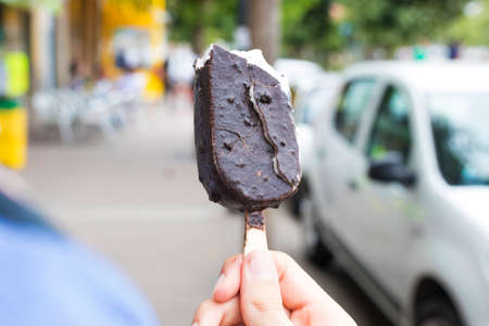 eating ice cream outdoors on the street in summer