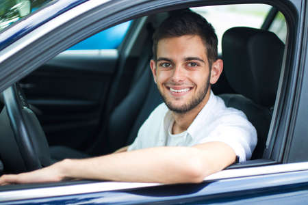 portrait of young adult in the car window smiling