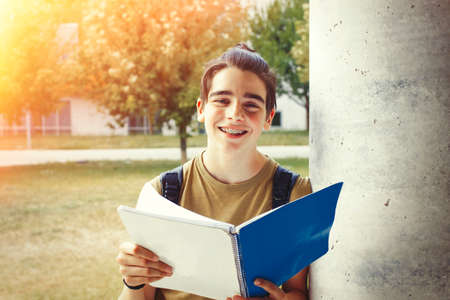 young student with notebook on campus or collegeの写真素材