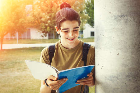 young student with notebook on campus or collegeの写真素材