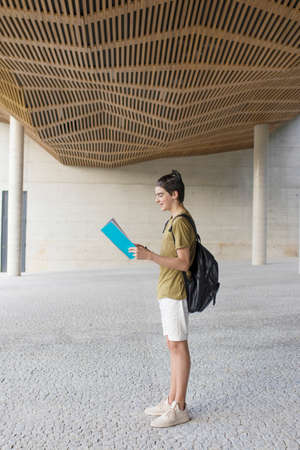 student with book backpack