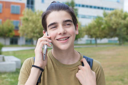 young teenager with outdoor mobile phoneの写真素材