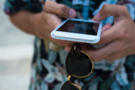 closeup your hands with your mobile phone or smartphoneの写真素材