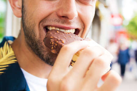 eating ice cream outdoors on the street in summerの写真素材