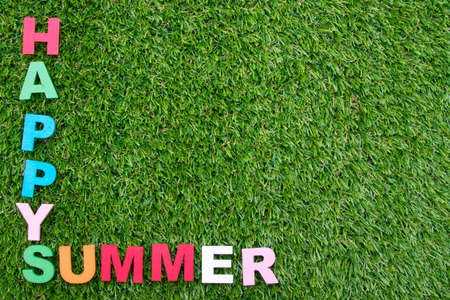summer background with letters on green grassの写真素材