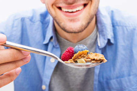 spoon with cereals and fruits, breakfast and healthy snack